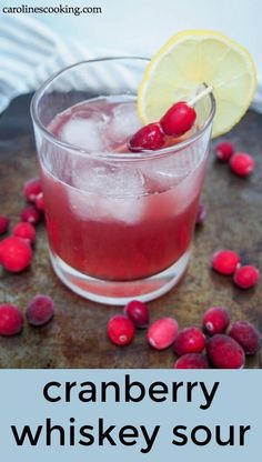 the cranberry whiskey sour is garnished with cherries