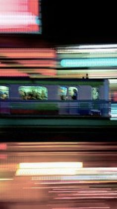 blurry photograph of train passing by at night