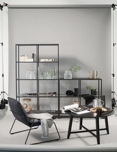 a living room filled with furniture and a glass door leading to a bedroom on top of a hard wood floor