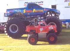 a large monster truck parked in front of a building