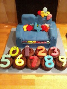 a birthday cake with cupcakes shaped like numbers