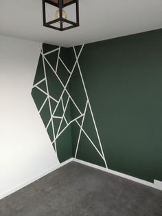 an empty room with green walls and white lines on the wall