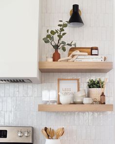 two wooden shelves above a stove in a kitchen