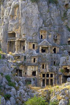 an ancient rock - cut city built into the side of a mountain