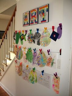 the wall is decorated with paper cutouts and pictures hanging on it's sides