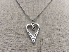 This is such a unique and whimsical heart pendant necklace.  It has incredible detail and another little heart showcased inside the main heart.  This would make a very sweet and meaningful gifts for a loved one on any occasion.  The heart measures 1” long by 5/8” wide and is made from allergy free plated silver.  It hangs from a simple 18” stainless steel necklace chain.I have matching earrings in my shop, if you would like the whole set.  Here is the link........... https://etsy.me/30EwF2x Than Silver Heart Jewelry, Whimsical Heart, Silver Heart Earrings, Silver Heart Pendant, Silver Heart Necklace, Unique Jewelry Designs, Love Necklace, Stainless Steel Necklace, Heart Pendant Necklace