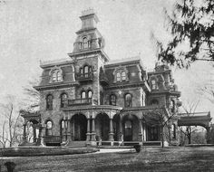 an old photo of a very large house