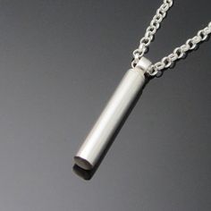 Eiremento Keepsake jewelry is a discreet way to keep the memory of your loved one close to you at all times. Large Tube cremation jewelry.The large tube keepsake pendant is completely handmade and comes on a heavyweight belcher chain. The keepsake pendant is crafted using the finest precious metals to ensure it lasts a lifetime. The bail discreetly twists off to allow for filling.Each piece is designed and made in Ireland using the highest quality precious metals.Available with a choice of chain Minimalist Keepsake Necklace With Round Pendant, Minimalist Round Pendant Necklace For Keepsake, Minimalist Stainless Steel Jewelry With Brushed Finish, Minimalist Engraved Jewelry For Keepsake, Minimalist Engraved Necklace For Keepsake, Minimalist Silver Keepsake Jewelry, Minimalist Engraved Keepsake Jewelry, Minimalist Keepsake Jewelry With Polished Finish, Minimalist Personalized Jewelry For Memorials