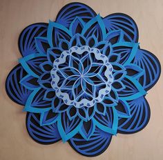 a paper cut out of a blue flower