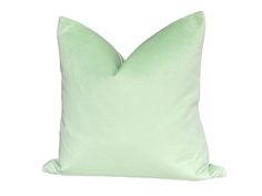 a light green pillow on a white background