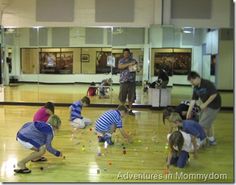 a group of children playing with toys in a gym