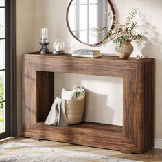 a wooden table with a mirror and vase on it