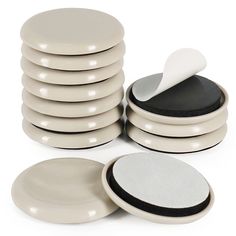 a stack of white and black plates next to each other