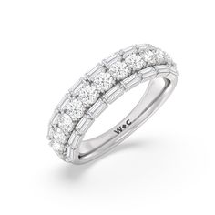 A classic half-eternity ring with a deep and diverse brilliance. This anniversary ring features a central arch of round diamonds sandwiched between two rows of baguette-cut diamonds. The edges of the shank are slightly ridged to follow the silhouette of the step-cut gems. Luxury Baguette Cut Diamond Ring For Anniversary, Luxury Diamond Ring With Single Cut Baguette Diamonds, Classic Diamond Ring With Baguette Cut, Classic Diamond Baguette Cut Rings, Luxury Baguette Cut Ring With Single Cut Diamonds, Luxury Baguette Diamond Ring For Anniversary, Classic Emerald Cut Baguette Diamond Ring, Platinum Diamond Ring With Baguette Diamonds For Anniversary, Classic Baguette Cut Diamond Ring