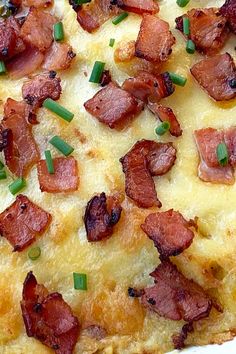 a close up of a pizza with bacon and cheese on it's toppings