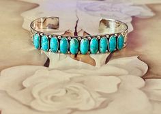 "Genuine Kingman Turquoise Bracelet.  She is so pretty with 10 beautiful stones with earthtone matrix in each stone.  Beautiful silversmith stamping on the sides. * Kingman Turquoise * Handcrafted and Hallmarked 925 Sterling silver * 5.5\" from end to end with a 1.5\" gap * Fits sizes 6.5\" to 8\" * FREE SHIPPING * Not Native Made" Turquoise Hoop Earrings, Turquoise Hoops, Beautiful Stones, Turquoise Crystal, Turquoise Bracelet Cuff, Squash Blossom Necklace, Southwestern Jewelry, Bracelet Cuff, Kingman Turquoise