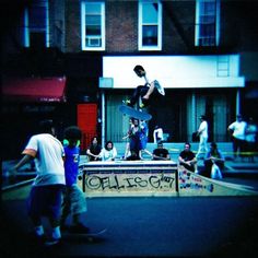 a group of young men riding skateboards down the side of a ramp