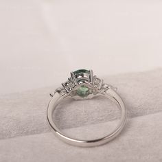 * The delicate ring displays lab green sapphire as main stone. The cluster side stones make the ring similar to the blooming flower . For who wearing this special & delicate ring, will shine like a goddess. ◆ Production Description: Main stone Type: Lab Green Sapphire Main Stone Shape: Oval Cut Main Stone Size: 6*8mm (1.75ct) Side stone: CZ Metal: 925 Sterling silver - Other options available in the drop down menu ◆ Customization: √Free for Add Engraving √Other Metal Type Available √Other Ge Oval Sapphire Ring For May Birthstone Wedding, Oval Green Birthstone Ring For Wedding, Green Sapphire Ring With Round Band For Wedding, Green Sapphire Round Band Wedding Ring, Green Sapphire Wedding Ring With Round Band, Oval Green Moissanite Emerald Ring, Oval Moissanite Emerald Green Ring, Oval Emerald Moissanite Ring, Oval Green Diamond Ring For Proposal