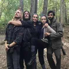 the walking dead cast posing for a photo in the woods with their arms around each other