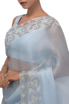 Blue saree enhanced with floral motif pearl and rhinestone embellishments. Comes with sleeveless blouse.
No of components: 2 
Neckline: Round 
Sleeve Length: Sleeveless 
Tassel tie-up bacl  
Sheer saree   - Aza Fashions Sheer Saree, Organza Saree With Blouse, Sarees Silk, Blue Saree, Blouse For Women, Organza Saree, Silk Organza, Saree With Blouse, Silk Twill