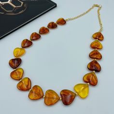 Elevate your style with our Golden Brown Heart Bead Necklace. This romantic statement piece features elegant golden brown heart-shaped beads on a long strand, creating a timeless look. Perfect for adding a touch of romance and sophistication to any outfit, this necklace is ideal for those who appreciate both charm and elegance in their jewelry collection. - Necklace length is 26" long and lightweight. Matching earrings are available. Select from the option drop-down menu "necklace + earrings" to White Chunky Necklace, Friends Necklace, Beautiful Hearts, Brown Beaded Necklace, Autumn Necklace, Long Statement Necklace, Christmas Necklace, Brown Necklace, Hearts Necklace