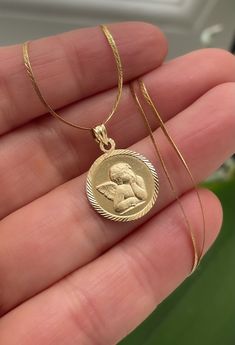 14K Solid Gold Angel Necklace | 14K Yellow Gold Angel Pendant with 14K Necklace | Cherub Necklace | Cherub Pendant | Guardian Angel | 2.67 g 14K solid yellow gold Angel / Cherub pendant on a 14K solid yellow gold chain. Excellent vintage pre-loved condition.  Measurements: Pendant 15 mm (W) x 15 mm (L) Pendant's Bale 5 mm Chain 40 cm / 16" (L) x 10 mm (W) Total weight 2.67 g Hallmark:  14K on pendant bale 14K , WG on necklace As with any well-loved piece, there may be slight imperfections picked up over its history including discoloration, scuffing or general wear.   Please examine photos closely.  Do not hesitate to reach out with questions. Thanks! Cherub Necklace, Guardian Angel Necklace, Angel Cherub, Gold Angel, Angel Necklace, Angel Pendant, Yellow Gold Chain, Guardian Angel, Solid Yellow