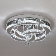 a crystal chandelier hanging from the ceiling in a room with white walls and ceilings