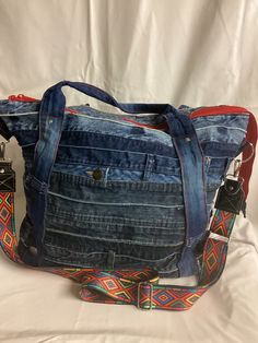 OOAK Denim tote bag. Slouchy bag.  Super roomy. Can be used as on oversized handbag, overnight bag etc It has a double layered outer pocket. Inside slip pocket. Detachable crossbody strap. Reinforced bottom. Measures approximately 17 x 12 x 5 On-the-go Hobo Bag With Pockets, Denim Tote Bag With Zipper Pocket, Travel Denim Bag With Zipper Pocket, Denim Travel Tote Bag, Casual Weekender Bag With Double Handle And Pockets, Casual Weekender Bag With Pockets And Double Handle, Rectangular Weekender Bag With Pockets For Everyday Use, Casual Satchel Weekender Bag With Pockets, On-the-go Weekender Shoulder Bag With Pockets