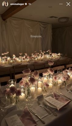 a long table with candles and flowers on it