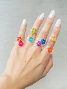 "✨Flower Resin Rings With Glitter Band ✨ A resin ring with a glitter band and a translucent flower.  You can wear it solo or layer it with other rings. Available in multiple colors. All are handmade and made with love. Each item is handcrafted using non-toxic material resin. Variations & imperfections are possible due to the nature of the materials used.  ✨DIMENSION:  Band Thickness: 2.5 mm (0.1\") (May vary depending on size) Band Width: 5mm (0.2\") (May vary depending on size) ✨ SHIPPING: All White Flower Ring For Party, Adjustable Clear Rings, Clear Plastic Jewelry For Gifts, Clear Plastic Jewelry As A Gift, Flower Shaped Plastic Jewelry As Gift, Clear Plastic Jewelry Gift, Flower-shaped Plastic Jewelry As Gift, Flower-shaped Plastic Jewelry Gift, Plastic Flower-shaped Jewelry For Gifts