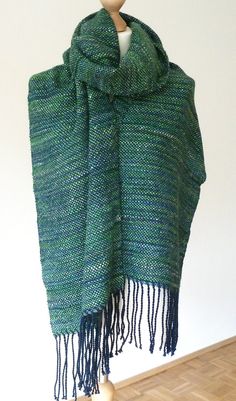 "I hand wove this scarf/shawl using luxury handspun and handdyed yarn made from natural fibres. I used a handspun handdyed yarn made of baby alpaca fleece, seacell & Angelina sparkle (weft) and a navy Merino silk yarn (warp). It is next to skin soft and extra wide so it could be used as a scarf or shawl. The seacell & silk give it a luxurious sheen measurements: approx. 210 x 35 cm / 82.5\" x 14\" (without fringe) and 236cm/ 92.5\" long (with fringe) materials: baby alpaca, seacell & silver Ange Hand Knitted Alpaca Shawl Scarves, Green Bohemian Handwoven Shawl, One Size Handwoven Alpaca Shawl, Handmade Mohair Shawl Scarf, Handwoven Alpaca Shawl, Handmade Alpaca Shawl Scarf, Bohemian Handwoven Alpaca Scarves, Hand Woven Scarf, Alpaca Fleece