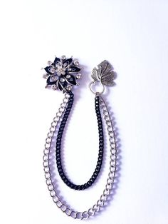 Looking for an accessory that exudes elegance and sophistication? Introducing our Elegant Crystal Lapel Pin with Silver/Black Chains! It is a stunning brooch pin designed for suits, tuxedos, blouses, and more. Made of high-quality crystal, alloy, and steel materials. This fashionable lapel pin serves as the perfect gift for both men and women, adding a touch of glamour to formal clothing, suits, and wedding attire. Its versatility makes it an ideal choice for various occasions. You can even pers Silver Brooch With Chain For Formal Occasions, Black Metal Brooch Jewelry, Formal Metal Brooch Pin, Black Formal Brooch Lapel Pin, Elegant Metal Brooches For Parties, Black Formal Lapel Brooch, Black Brooch For Formal Occasions, Black Brooch Jewelry For Wedding, Black Brooch Pins For Evening