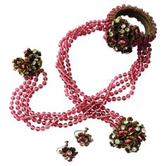 Beautiful three piece parure (wraparound necklace with jewelled terminals, wraparound bracelet and matching earrings), a iconic design from the 1930s by Miriam Haskell. In soft cranberry pate de verre glass, the necklace wraps round the neck, the terminals clipping on to oppsoing sides of the collar. The earrings are a screwback fitting but can be easily converted. These jewels were sold in Harvey Nichols department store in London, during the 1930s. Miriam Haskell was born in 1899, opening her Yellow Stone Pendant, Vintage Diamond Necklace, Beading Necklaces, Baroque Necklace, Necklaces Beaded, Miriam Haskell Jewelry, Multi Strand Beaded Necklace, Vintage Beads Necklace, Brown Necklace