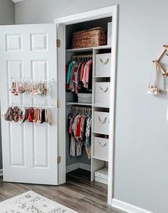 an organized closet with white doors and drawers