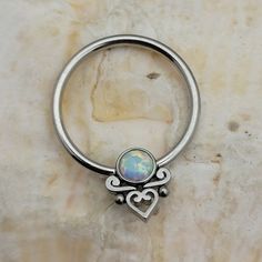 One (1) New Captive Bead Ring With White Opal Inset Stone Decorated With Filigree Heart. Surgical Steel Cbr Size: 16g - 3/8" - 10mm Ball Size: 10mm Ring - 3mm Bead All Jewelry Is Brand New. If You Have Any Questions At All, Please Let Us Know.If You Have Had A Reaction To A Material In The Past, We Do Not Recommend Ordering Or Wearing Any Jewelry Made With That Material As It Could Cause A Reaction. All Jewelry Should Be Removed When Showering Or Swimming As Harsh Chemicals Such As Abrasive Soap Adjustable White Body Jewelry As Gift, Adjustable Silver Heart Body Jewelry, Cute Septum Rings, Captive Bead Ring, Septum Rings, Filigree Heart, Smoky Quartz Ring, Septum Jewelry, Natural Diamond Ring