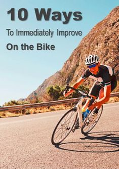 a man riding on the back of a bike down a road with mountains in the background