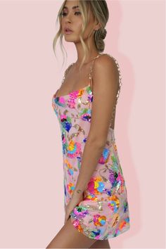 The Celebration Time Sequin Backless Mini Dress is the only reason you'll need to start the celebration! Crafted from embellished mesh overlay with delicate embroidered fluorescent and pastel flowers & sequins together with 100% poly lining. This gorgeous mini has a relaxed oversized fit throughout with a cowl neckline & plunging back. The stunning gold strap detailing attach near the bust with a super low back. Featuring a super cute flowy hem to create a flirty feel to this slip -making it a p Selena Dresses, Multicolor Sequins, Backless Mini Dress, Shades Of White, Flowy Skirt, White Mini Dress, Sequin Dress, Pink Dress, Taylor Swift