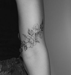 a woman with a flower tattoo on her arm