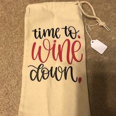 a wine bag with the words time to wine down printed on it and a tag