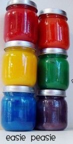 four jars filled with different colored liquids