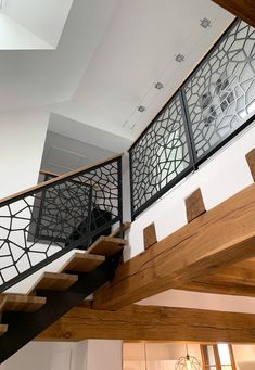 a stair case with metal railing and wood handrail