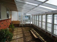 the inside of a building with several windows and benches on the ground in front of it