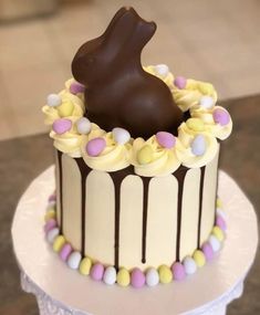 there is a chocolate bunny on top of the cake, and it's ready to be eaten