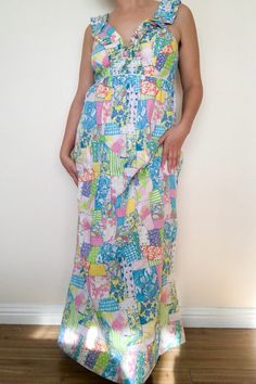 Lilly Pulitzer Pastels Baby Doll Maxi Dress. Empire waist cut, maxi length. Fun and colorful patchwork pattern throughout. Ruffled neckline that goes up into the shoulder straps of the dress. Zipper closure going up the back. Has an interior half-slip. Linen-cotton blend. Excellent vintage condition, marked size 6. Approx. Measurements Length: 56" Underarm to Underarm: 16 1/2" Beach Dresses In Vibrant Print, Free Size, Lilly Pulitzer White Dress, Lilly Pulitzer Prints Blue, Lilly Pulitzer Disney Print, Half Slip, Vintage Lilly Pulitzer 1960s, Maxi Tank Dress, Measurement Length, Patchwork Patterns