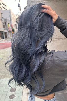 Cool-toned blue-gray balayage waves for a unique and stunning hairstyle. Bluish Hair Color, Grey And Blue Hair Color, Fun Color Ideas For Blondes, Blue In Hair Ideas, Soft Blue Hair Color, Dark Silver Blue Hair, Unique Hair Colour Ideas, Denim Blue Hair Color, Dark Blue Grey Hair