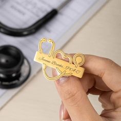 a person holding up a key to a piece of paper with the word love on it