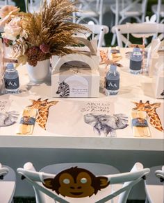 the table is set up for an animal themed baby shower