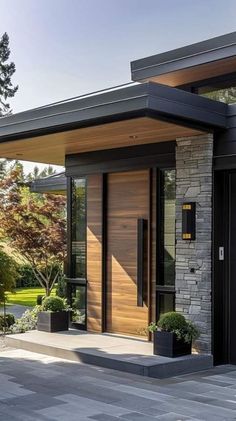 the entrance to a modern home with stone and wood