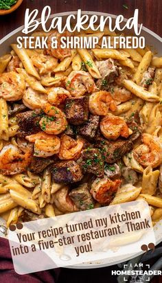 a plate full of pasta with shrimp and shrimp in it, on top of a wooden table