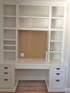 a white desk and bookcase in a room